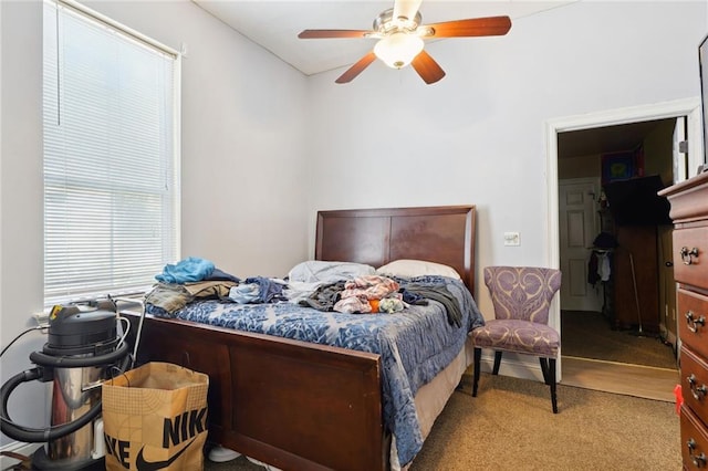 bedroom featuring ceiling fan and carpet