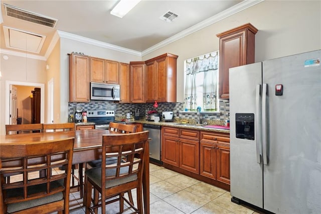 kitchen with appliances with stainless steel finishes, decorative backsplash, light stone counters, light tile patterned floors, and crown molding