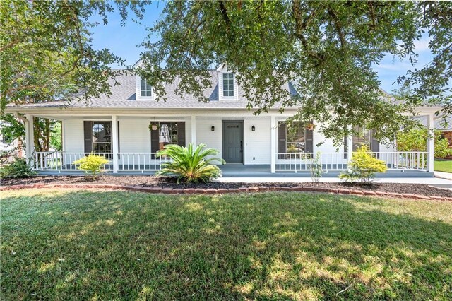 cape cod home with covered porch and a front yard