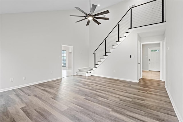 interior space featuring ceiling fan, high vaulted ceiling, and hardwood / wood-style floors