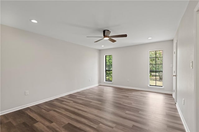 unfurnished room featuring ceiling fan, wood-type flooring, and plenty of natural light