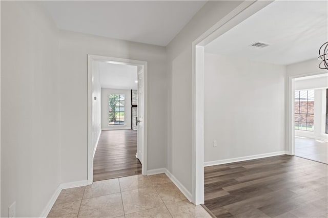 hallway with light hardwood / wood-style floors