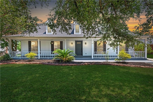 view of front of property with a lawn and a porch