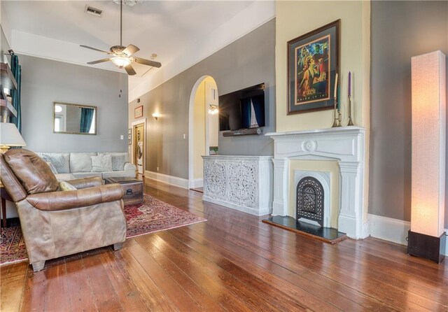 living room featuring ceiling fan and hardwood / wood-style flooring