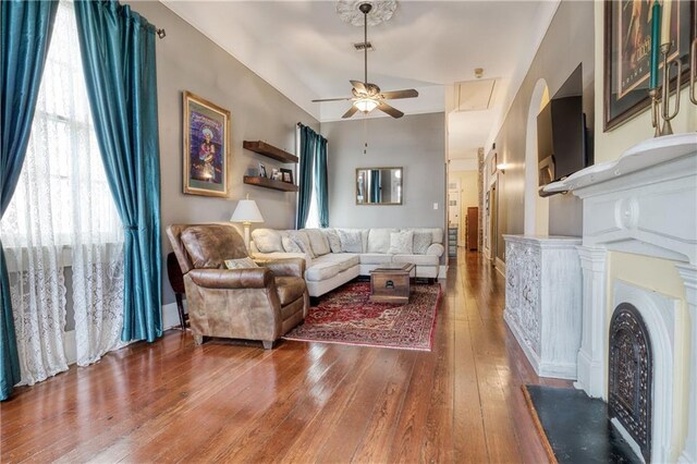 living room featuring hardwood / wood-style floors and ceiling fan