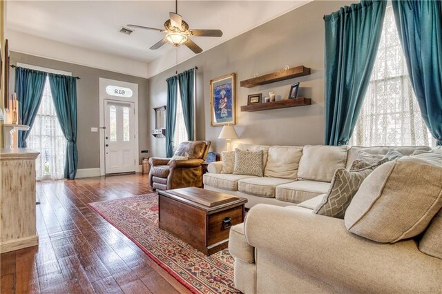 living room featuring ceiling fan and dark hardwood / wood-style floors