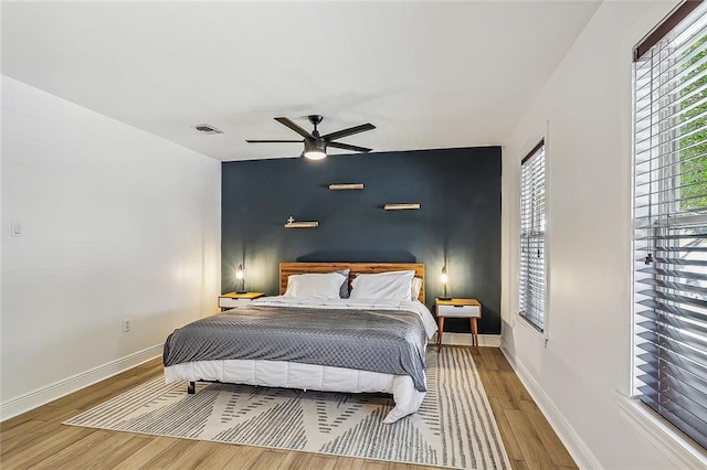 bedroom with ceiling fan and light hardwood / wood-style flooring