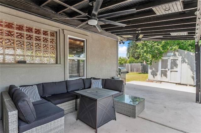 view of patio with ceiling fan, a storage unit, and an outdoor hangout area