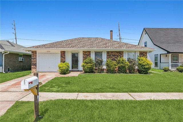 single story home with a garage and a front lawn