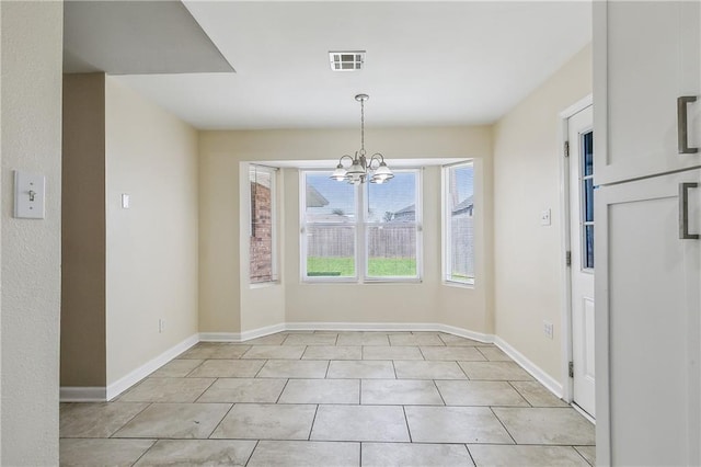 unfurnished dining area with light tile patterned floors and an inviting chandelier