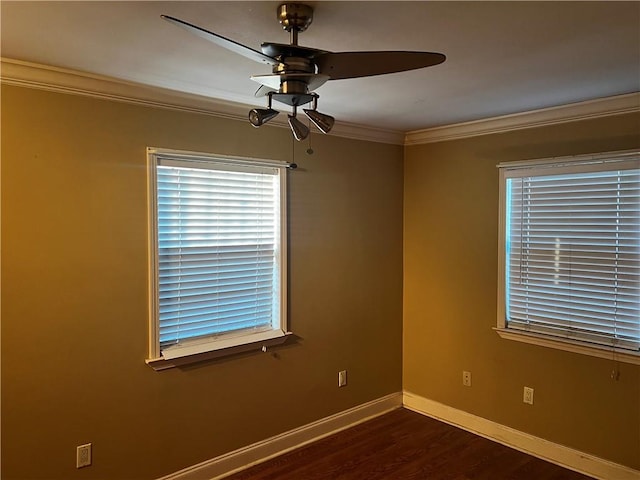 spare room featuring ceiling fan, dark hardwood / wood-style flooring, and crown molding