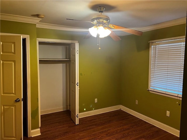 unfurnished bedroom with dark hardwood / wood-style flooring, a closet, ornamental molding, and ceiling fan