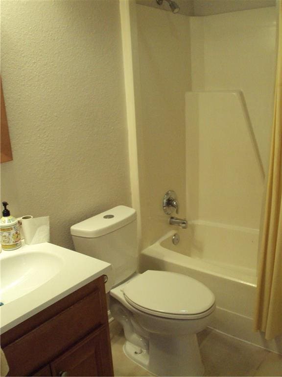 full bathroom featuring toilet, vanity, shower / tub combination, and tile patterned floors