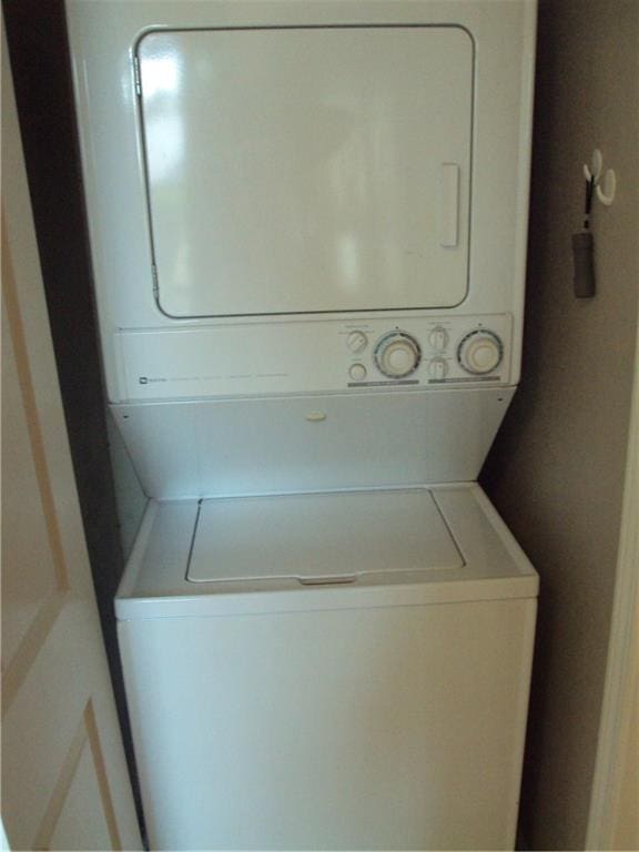 laundry area with stacked washer / dryer