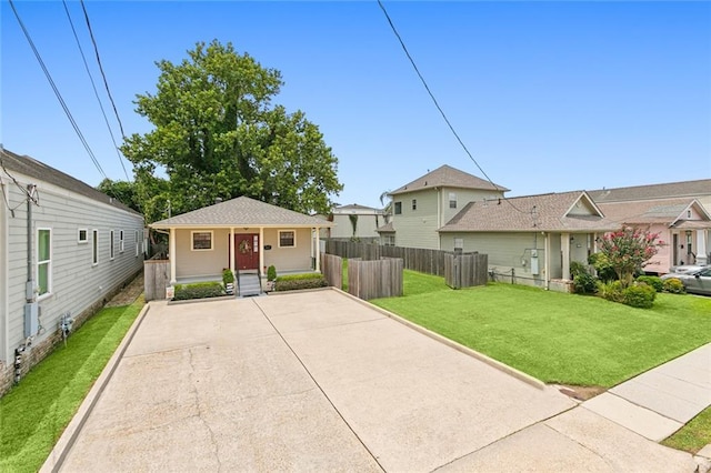 view of front of home with fence and a front yard