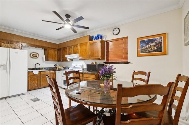 dining room with light tile patterned flooring, a ceiling fan, and crown molding