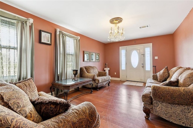 living room featuring wood-type flooring and a notable chandelier