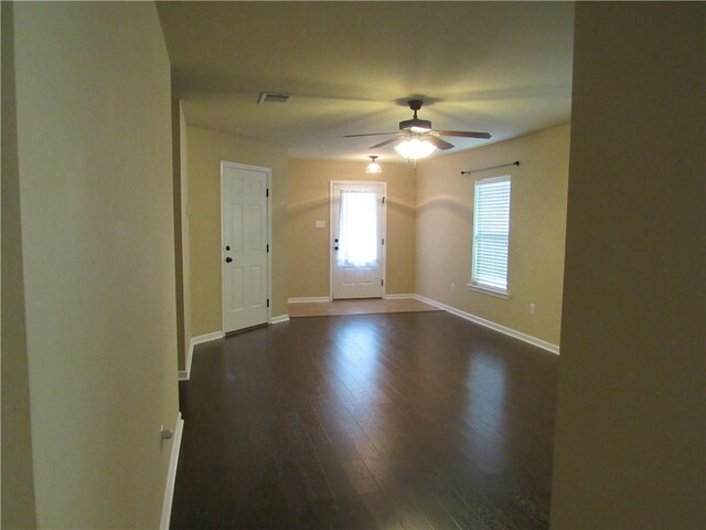 spare room with dark hardwood / wood-style flooring and ceiling fan