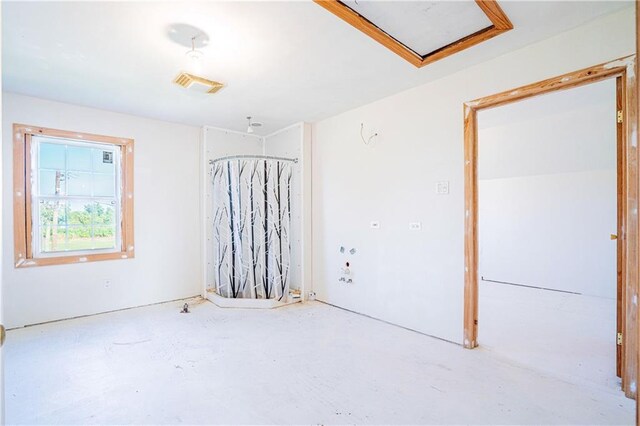 unfurnished room featuring concrete flooring