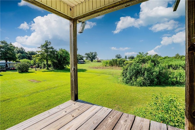 wooden deck featuring a yard