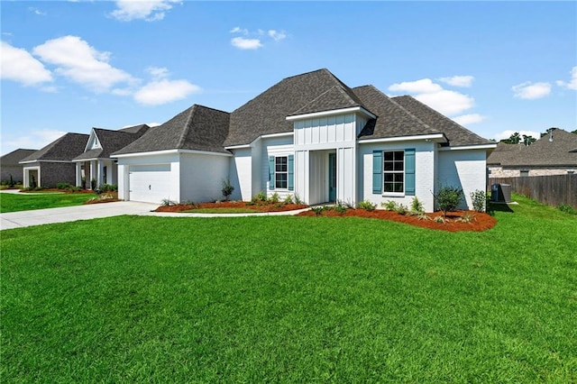 view of front of property with a garage and a front yard