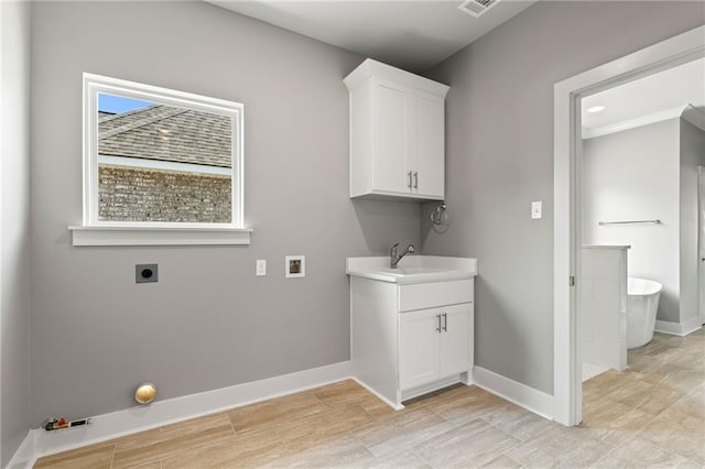 laundry area featuring washer hookup, cabinets, sink, and electric dryer hookup