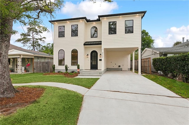 view of front of property featuring a front lawn and a carport