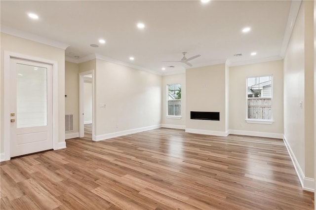 unfurnished living room featuring ceiling fan, light hardwood / wood-style flooring, and ornamental molding