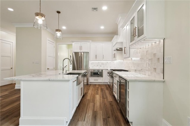 kitchen with wine cooler, white cabinets, backsplash, pendant lighting, and dark hardwood / wood-style floors