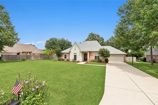 view of front of property featuring a garage and a front lawn