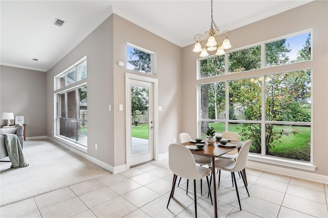 tiled dining area with a notable chandelier and crown molding