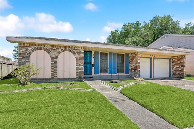 503 Wright Ave, Terrytown, LA 70056 - view of front of property with a garage, fence, a front yard, brick siding, and driveway