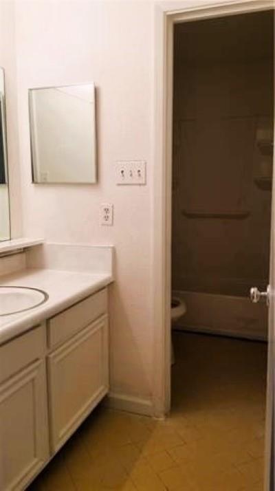 bathroom featuring vanity, toilet, walk in shower, and tile patterned floors