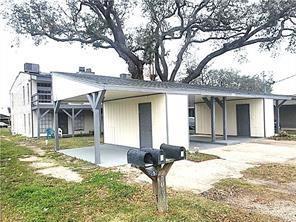 back of property with a carport