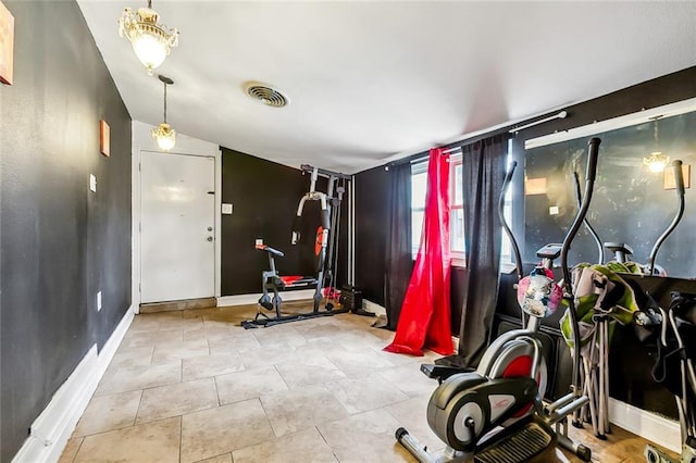 workout area featuring light tile patterned flooring