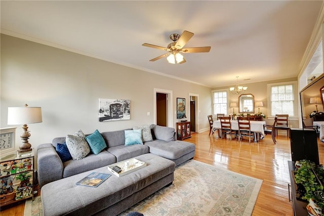 living room featuring crown molding, ceiling fan with notable chandelier, and light wood-type flooring