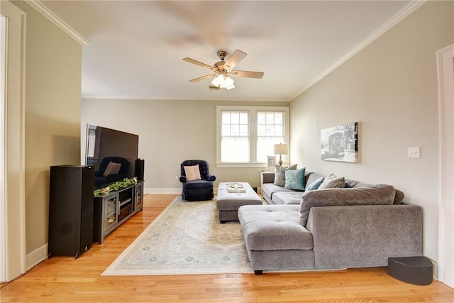 living room featuring ceiling fan, light hardwood / wood-style flooring, and ornamental molding