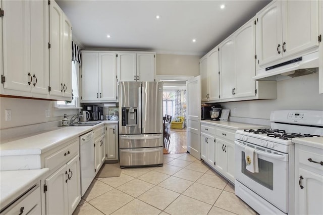 kitchen with sink, white cabinetry, white appliances, and light tile patterned floors