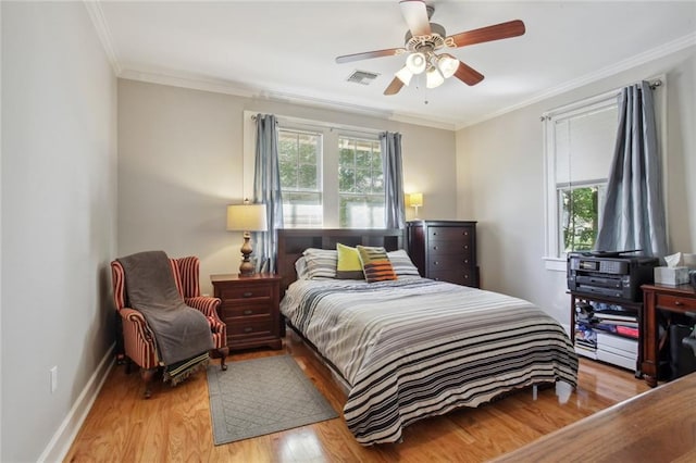 bedroom with light hardwood / wood-style floors, ornamental molding, ceiling fan, and multiple windows