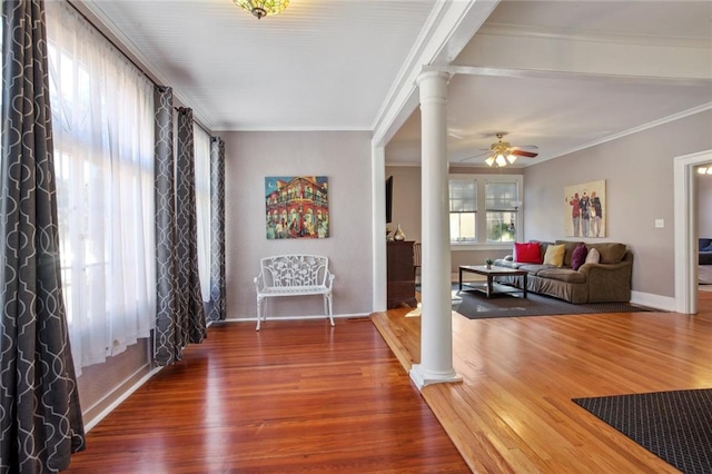 interior space featuring ornate columns, hardwood / wood-style floors, and ceiling fan