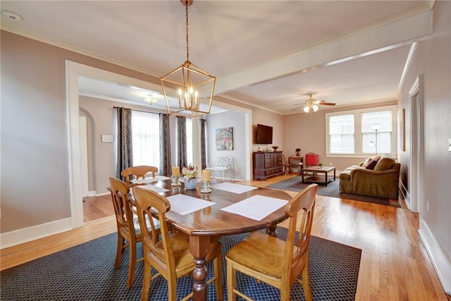 dining room with crown molding, light hardwood / wood-style flooring, and ceiling fan with notable chandelier