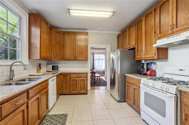 kitchen with sink, white appliances, light hardwood / wood-style floors, and plenty of natural light