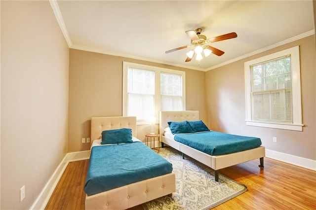 bedroom with ceiling fan, crown molding, and hardwood / wood-style flooring