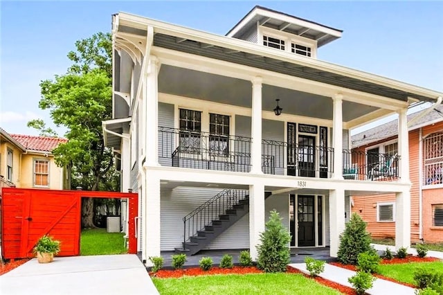 rear view of house featuring a balcony and central air condition unit