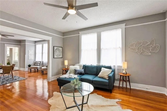 1831 S Dupre St, New Orleans, LA 70125 - living room with a textured ceiling, wood finished floors, ceiling fan, and baseboards
