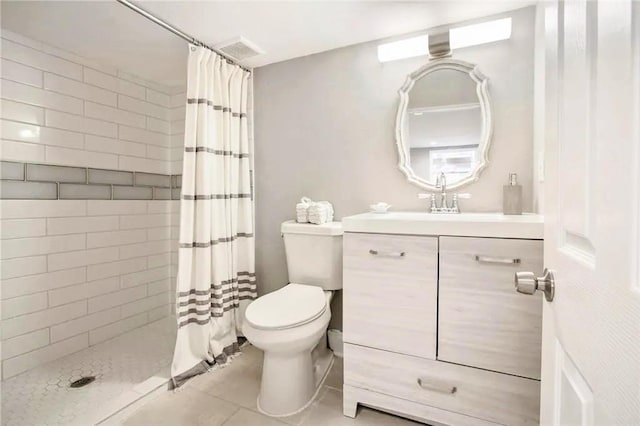 bathroom featuring vanity, a shower with curtain, tile patterned floors, and toilet