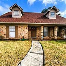 view of front of house with covered porch and a front lawn