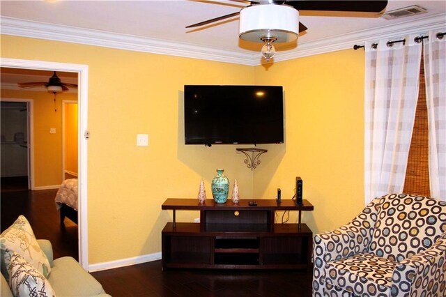 living room with crown molding, dark wood-type flooring, and ceiling fan