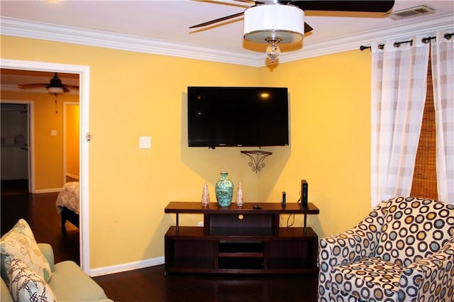 living area featuring crown molding, wood finished floors, visible vents, and ceiling fan