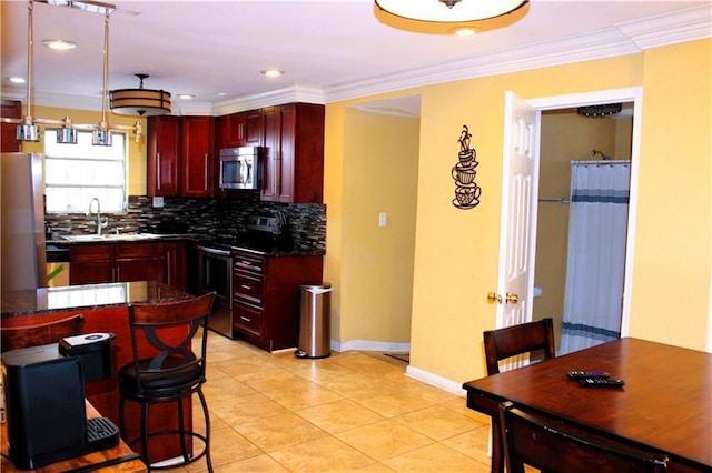 1831 N Miro St, New Orleans, LA 70119 - kitchen featuring crown molding, dark brown cabinets, appliances with stainless steel finishes, a sink, and dark countertops